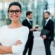 a confident businesswoman in glasses and a suit, representing empowerment in a self-esteem course setting