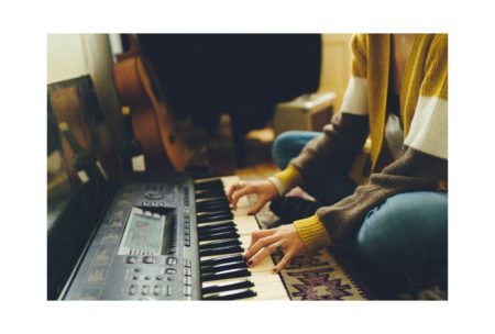 composer playing electric organ