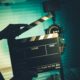 a person holds a clapper board in front of a camera, symbolizing a video production course in action