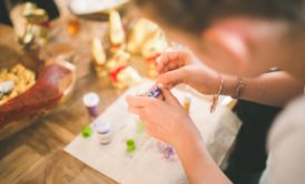 a woman skillfully crafts with colorful beads, showcasing creativity and inspiration Etsy for beginners
