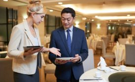 A woman in business attire, aspiring to become an event planner, engaged in a discussion about plans for an event