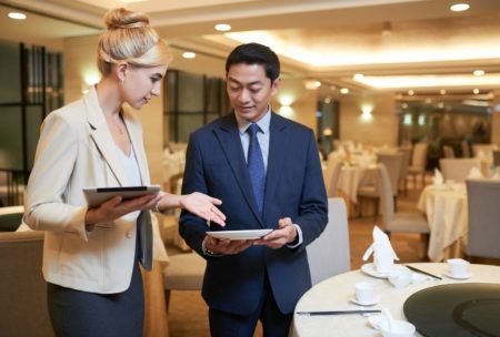 A woman in business attire, aspiring to become an event planner, engaged in a discussion about plans for an event