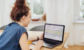 woman using excel on black laptop