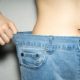 woman's midsection in jeans, promoting Lose Belly Fat goal