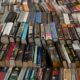 a large pile of books, symbolizing the wealth of knowledge available in fiction writing courses