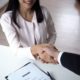 a woman and man shaking hands at a desk, symbolizing how to find your perfect job
