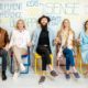 people sitting on chairs with words on them promoting be happier with positive psychology