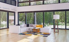 A stylish living room showcasing ample windows and beautiful wood flooring - Introduction To Interior Design