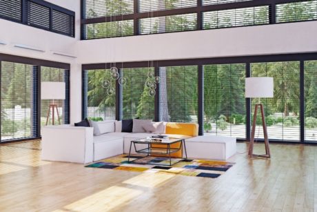 A stylish living room showcasing ample windows and beautiful wood flooring - Introduction To Interior Design