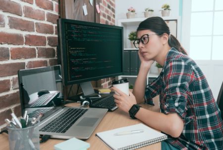 female python programmer holding cup