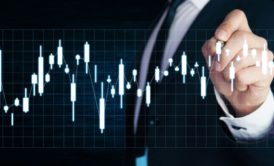 a man in a suit points at a data chart during a stock investing course presentation