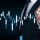 a man in a suit points at a data chart during a stock investing course presentation