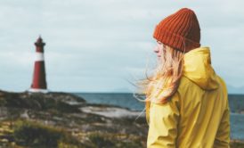 woman in yellow jacket norwegian landscape