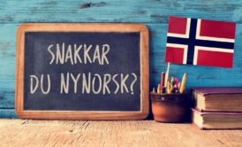norwegian flag and greeting written on blackboard