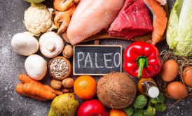 The word 'paleo' surrounded by a variety of nutritious foods for Paleo Cooking Meal Prep