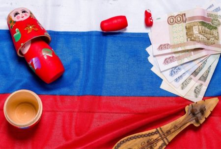 an image depicting the Russian ruble, alongside matryoshka representing a russian language course