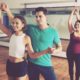 An energetic group session in a dance studio, where people joyfully practice salsa dancing for beginners