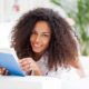 Curly-haired woman deeply engaged in reading Speed Reading Simplified book