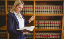 a lawyer reviewing legal texts in a law library, boosting your productivity through focused research and study