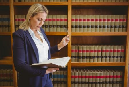 a lawyer reviewing legal texts in a law library, boosting your productivity through focused research and study