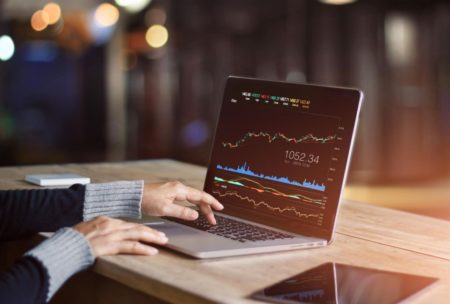 a determined individual analyzing stock market data, symbolizing a trading mindset