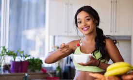 woman in green sports bra eating healthy food