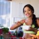woman in green sports bra eating healthy food