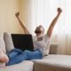 a man relaxes on a couch with his feet up, working on a laptop while exploring how to get jobs on upwork