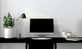 Work area organization showcased in a tidy setup with a black desk, computer, and chair for enhanced productivity.