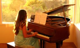 woman playing grand piano