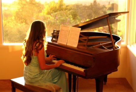 woman playing grand piano