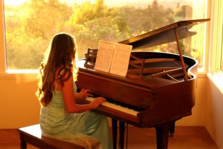 woman playing grand piano