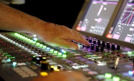 man operating audio mixer