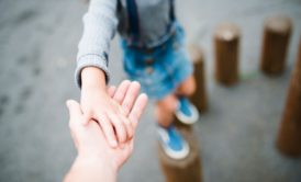 father holding son's hand