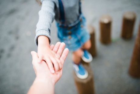 father holding son's hand