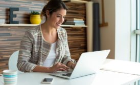 woman working on pinterest white laptop