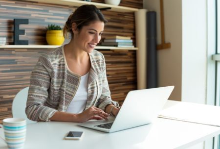 woman working on pinterest white laptop