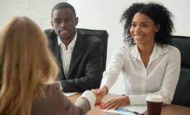 applicant shaking hands with hiring managers in job interview