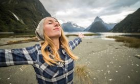 woman spreading hands looking up the sky