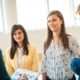 three professionals conversing in an office, focusing on goal setting theory of motivation