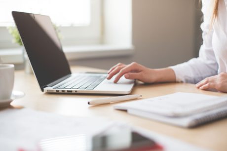 woman working on silver laptop