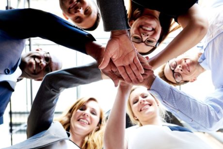 team unity putting hands together