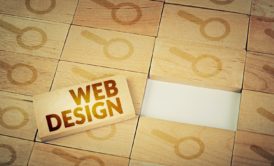 wooden block web design and magnifying glass