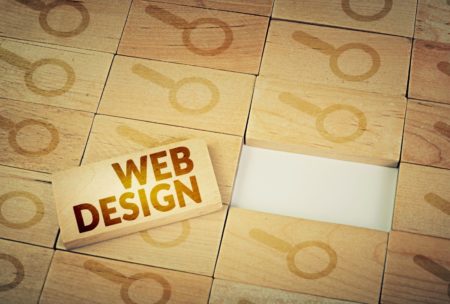 wooden block web design and magnifying glass