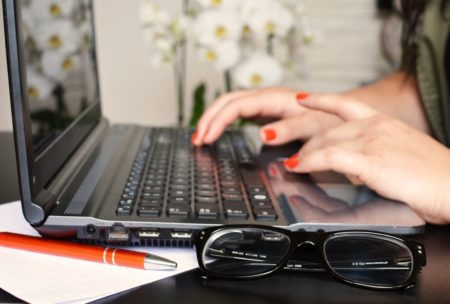 woman typing on windows 10 laptop