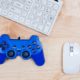 white keyboard mouse and blue game controller