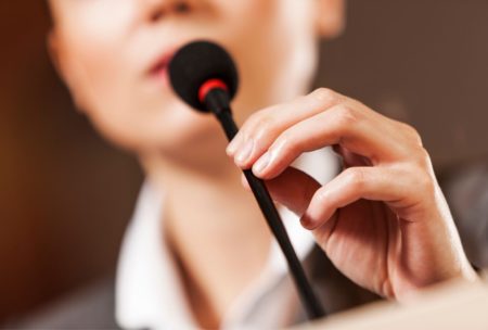 public speaker holding mic