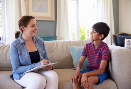 child psychiatrist talking to boy