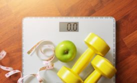 weighing scale green apple and dumbbell