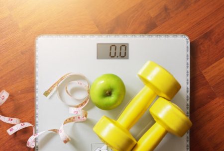weighing scale green apple and dumbbell